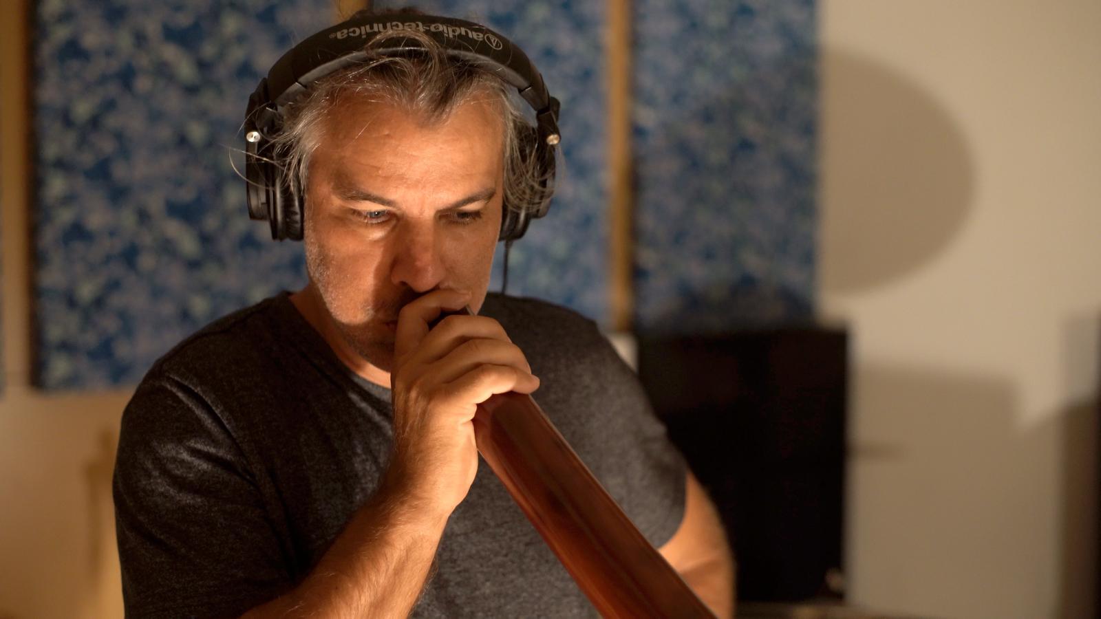 artist playing didgeridoo